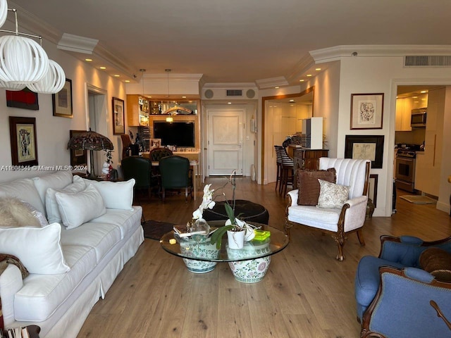 living room with crown molding and wood-type flooring