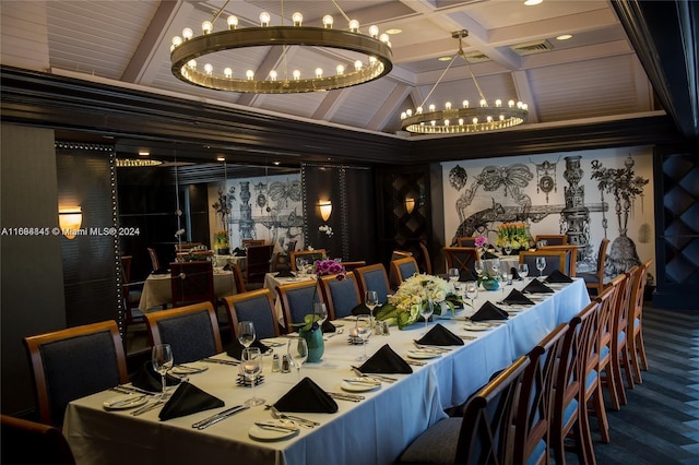 dining area with hardwood / wood-style floors, a notable chandelier, and beam ceiling