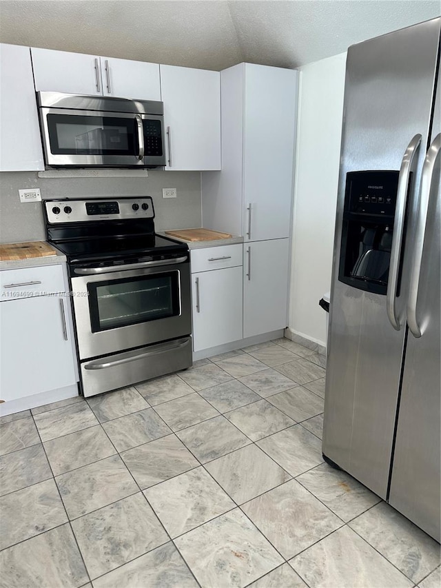 kitchen featuring white cabinets and appliances with stainless steel finishes