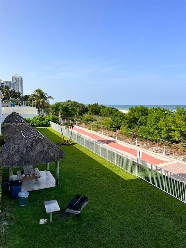 view of yard featuring a gazebo, a patio area, and a water view