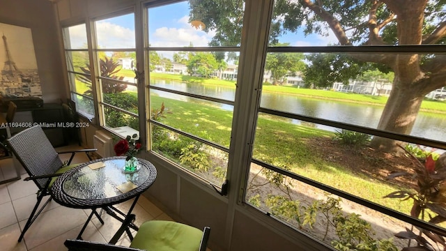 sunroom / solarium with a water view