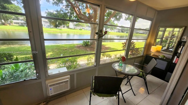 sunroom / solarium featuring a water view