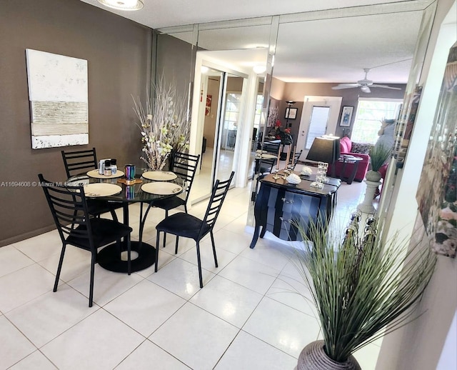 tiled dining room with ceiling fan