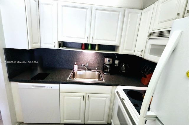 kitchen with white cabinets, backsplash, white appliances, and sink