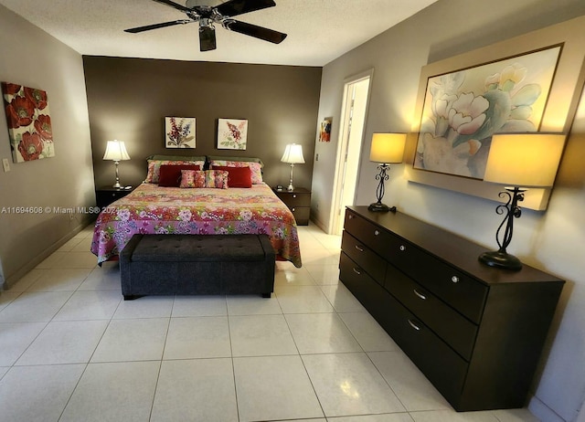 bedroom featuring light tile patterned floors, a textured ceiling, and ceiling fan