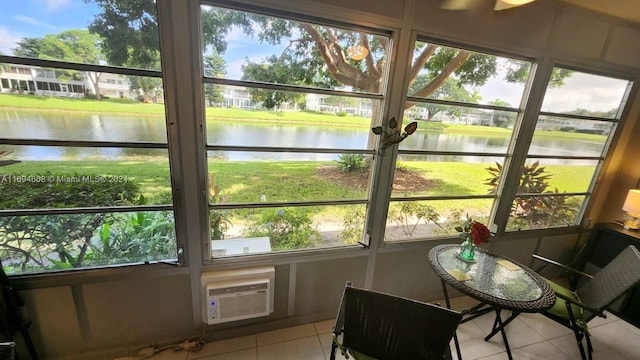 sunroom featuring a healthy amount of sunlight and a water view