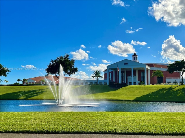 view of property's community featuring a water view and a lawn