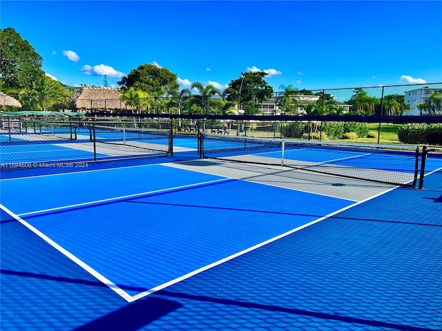 view of tennis court featuring basketball court