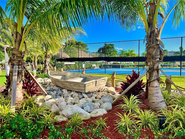 view of swimming pool featuring tennis court