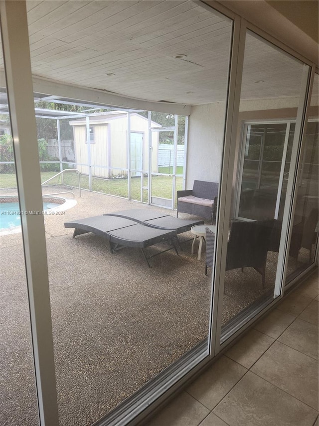 unfurnished sunroom featuring wooden ceiling