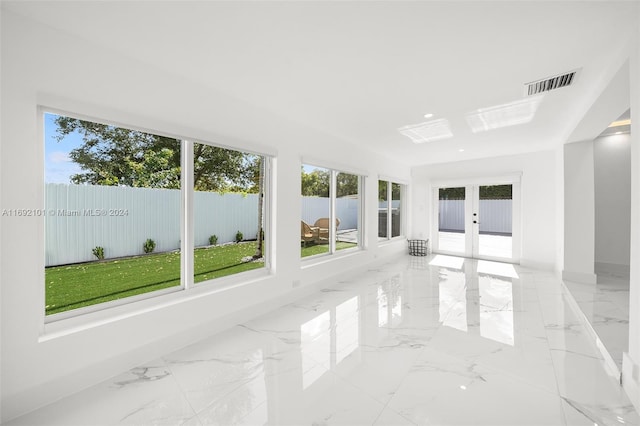 unfurnished sunroom with french doors