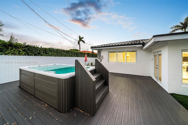 deck featuring french doors and a hot tub