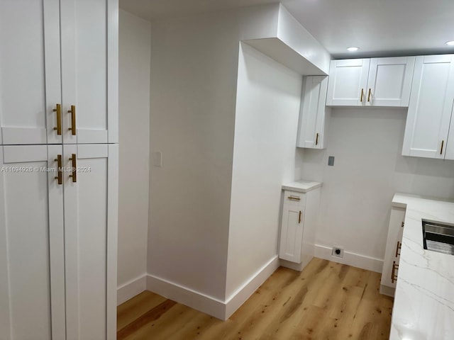 laundry room with light hardwood / wood-style flooring