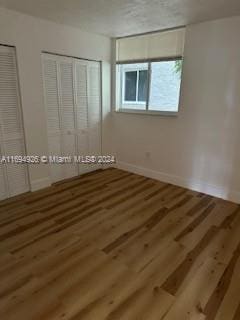 unfurnished bedroom featuring hardwood / wood-style flooring