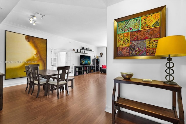 dining space featuring hardwood / wood-style floors and ornamental molding