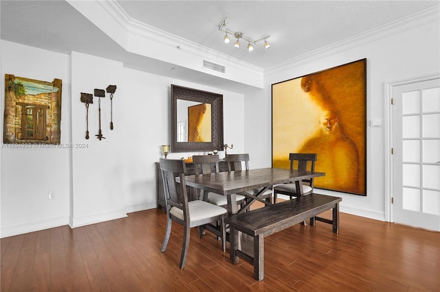 dining area featuring crown molding and hardwood / wood-style flooring