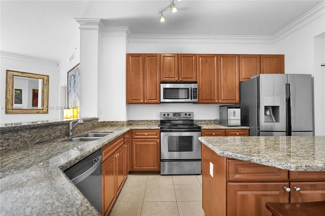 kitchen featuring light stone countertops, sink, ornamental molding, and appliances with stainless steel finishes