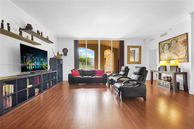 living room featuring hardwood / wood-style floors, a wall of windows, and crown molding