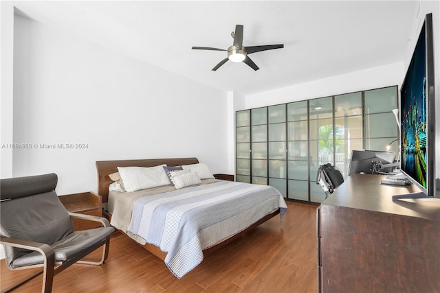 bedroom with ceiling fan and dark hardwood / wood-style flooring