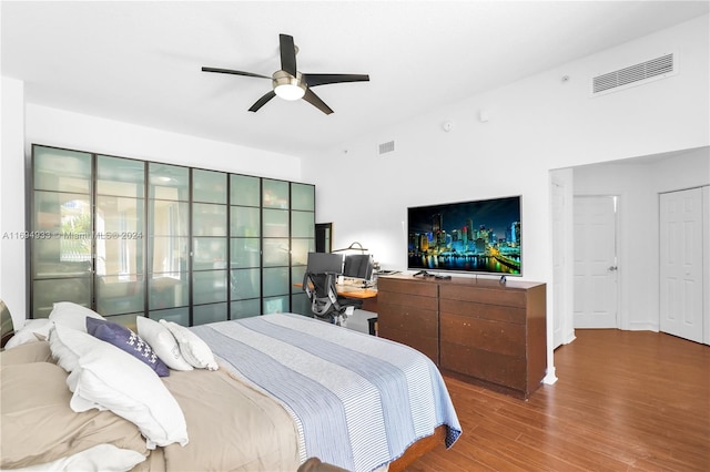 bedroom with hardwood / wood-style floors and ceiling fan