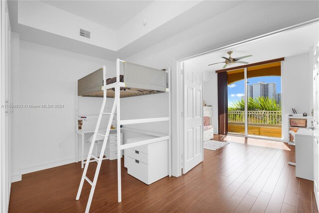 unfurnished bedroom featuring dark wood-type flooring and access to outside