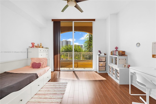 bedroom featuring ceiling fan, wood-type flooring, and access to outside