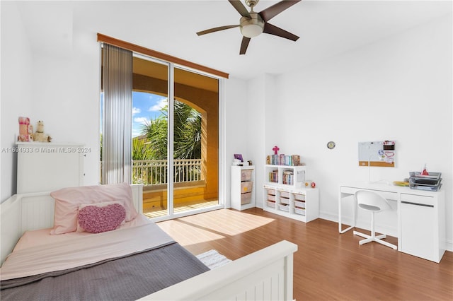 bedroom featuring access to outside, ceiling fan, and dark wood-type flooring