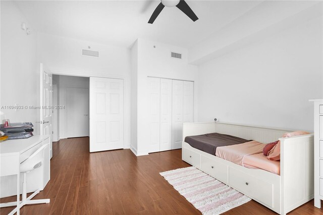 bedroom with ceiling fan, a closet, and dark hardwood / wood-style floors