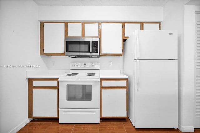 kitchen with white cabinets and white appliances