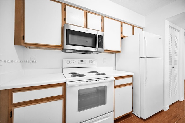 kitchen with white cabinetry, light hardwood / wood-style flooring, and white appliances