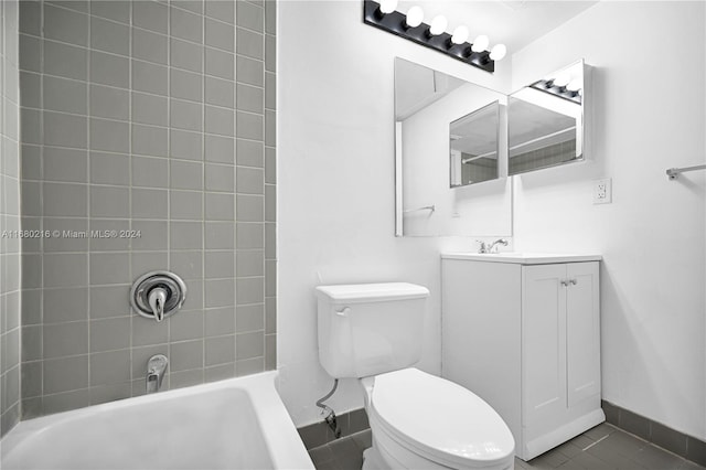 full bathroom with tile patterned floors, tiled shower / bath, vanity, and toilet