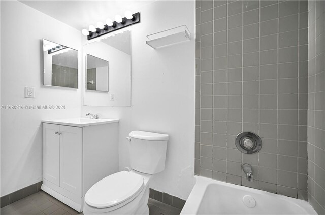 full bathroom with tile patterned flooring, vanity, toilet, and tiled shower / bath