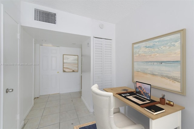 office featuring light tile patterned floors and a textured ceiling