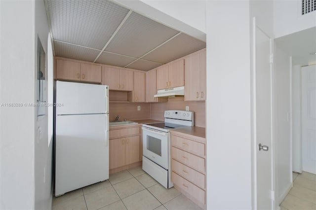 kitchen with light brown cabinets, sink, backsplash, white appliances, and light tile patterned floors