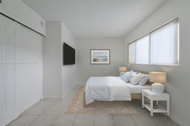 tiled bedroom featuring a textured ceiling