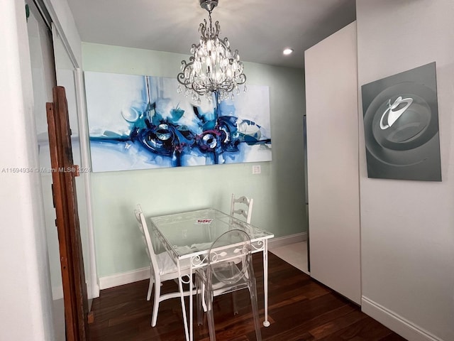 dining area featuring a chandelier and dark wood-type flooring