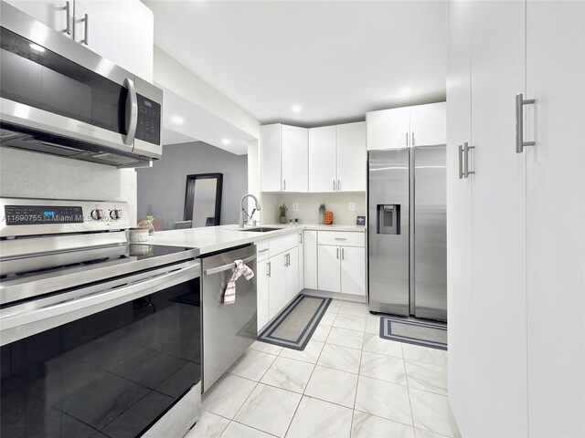 8415 SW 107th Ave Unit 356W, Miami, FL 33173 - kitchen featuring stainless steel appliances, a sink, light countertops, white cabinets, and backsplash