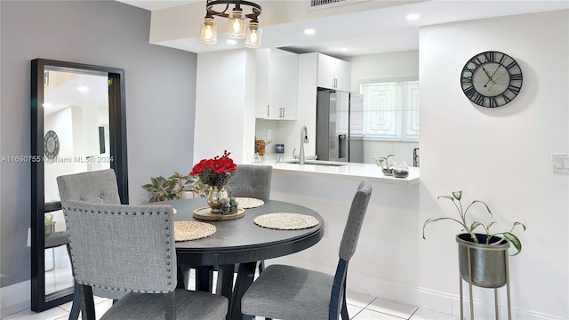 tiled dining space featuring sink