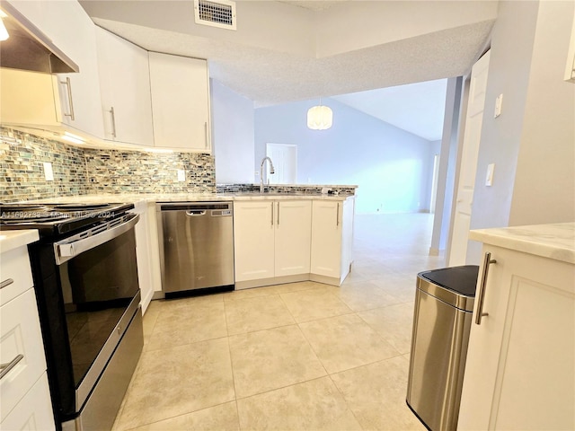 kitchen with decorative backsplash, stainless steel appliances, pendant lighting, white cabinetry, and range hood