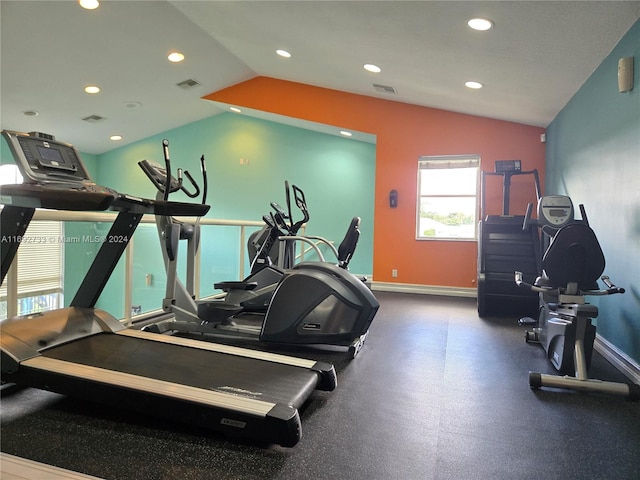 gym featuring vaulted ceiling