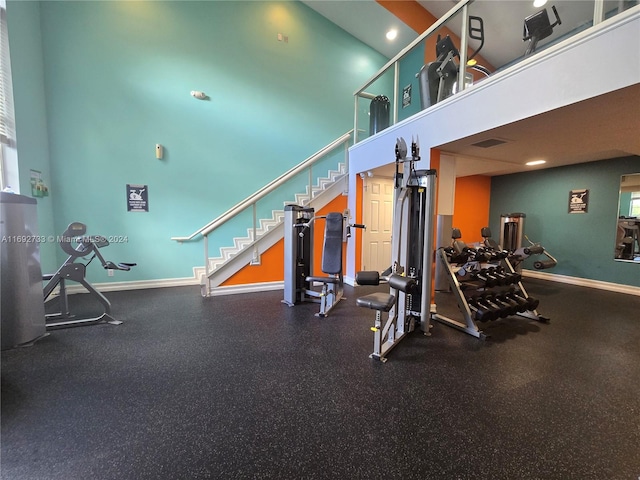 workout area featuring a high ceiling