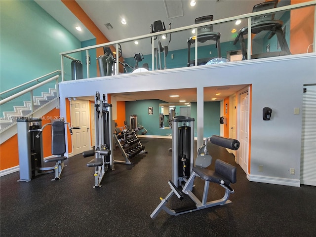 workout area with a towering ceiling