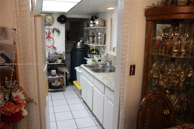 bar with a skylight, white cabinetry, sink, and light tile patterned floors