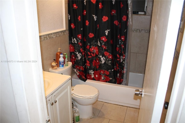 full bathroom featuring toilet, vanity, tile patterned floors, and shower / bath combo with shower curtain