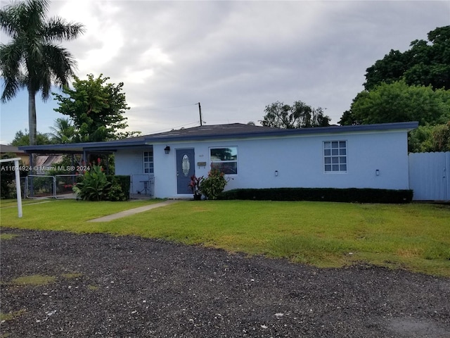 single story home featuring a carport and a front lawn