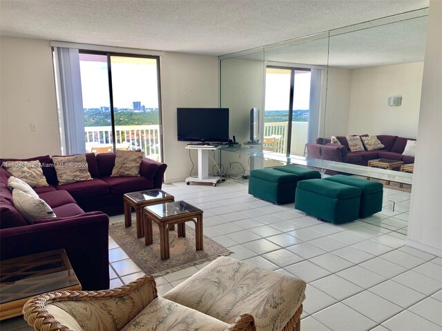 1500 S Ocean Dr Unit 17E, Hollywood, FL 33019 - living room featuring light tile patterned floors, plenty of natural light, and a textured ceiling