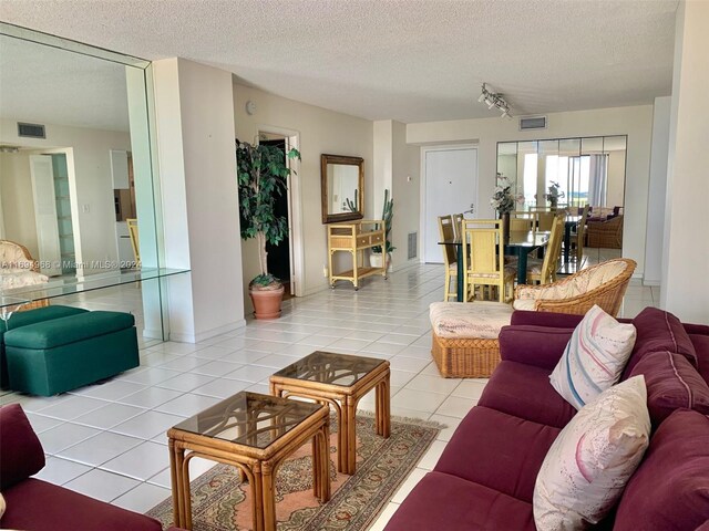 1500 S Ocean Dr Unit 17E, Hollywood, FL 33019 - living room featuring a textured ceiling and light tile patterned flooring