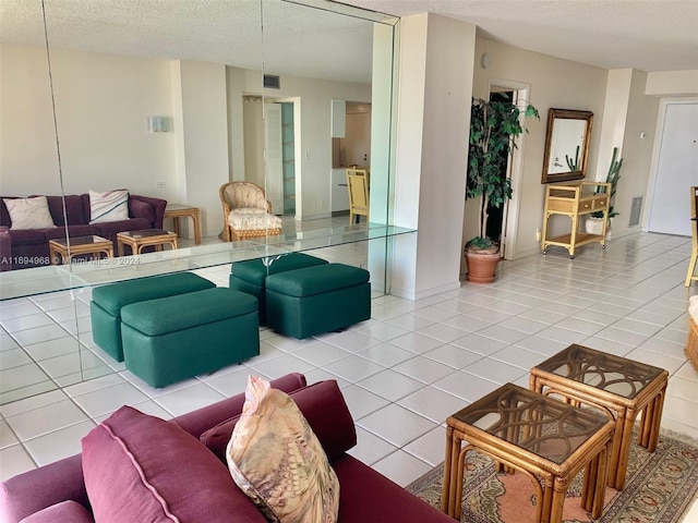 1500 S Ocean Dr Unit 17E, Hollywood, FL 33019 - living room with a textured ceiling and light tile patterned flooring