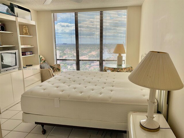 1500 S Ocean Dr Unit 17E, Hollywood, FL 33019 - bedroom with light tile patterned flooring, multiple windows, and a textured ceiling