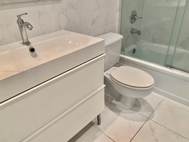 1500 S Ocean Dr Unit 17E, Hollywood, FL 33019 - bathroom featuring toilet, enclosed tub / shower combo, marble look tile flooring, and vanity